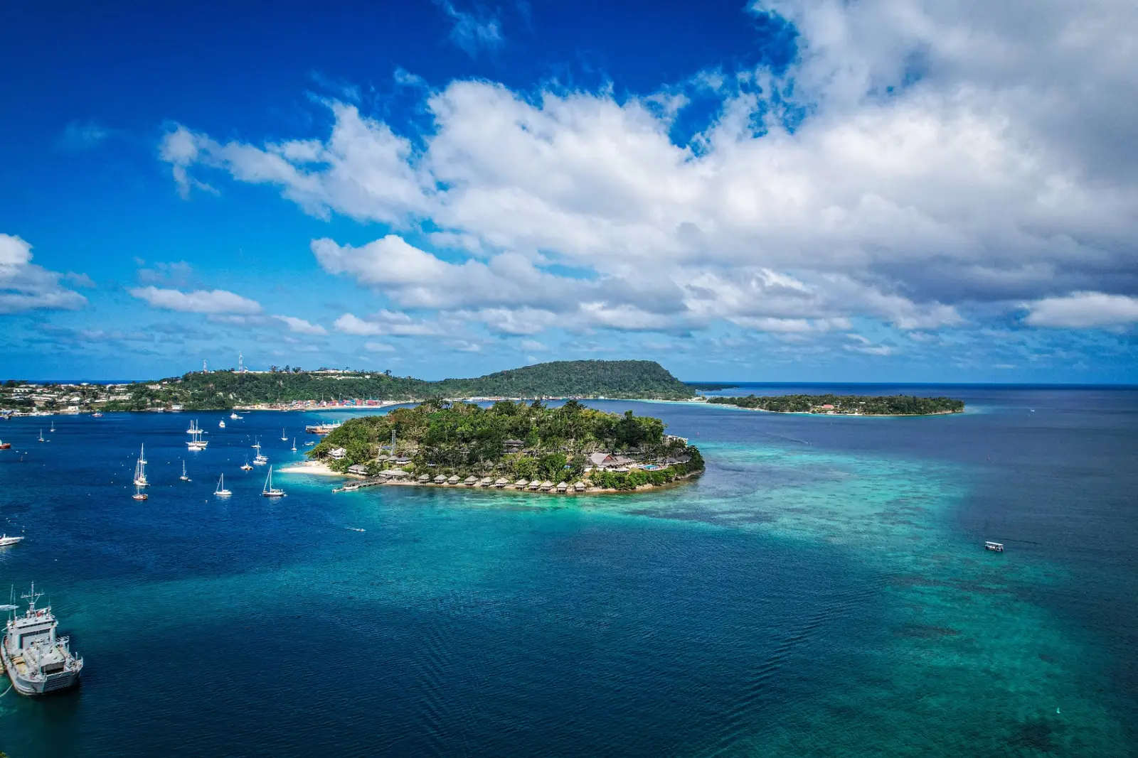 Port Vila harbour at golden hour with luxury yachts